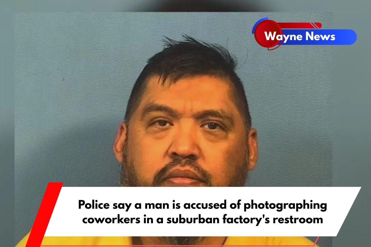 Police say a man is accused of photographing coworkers in a suburban factory's restroom